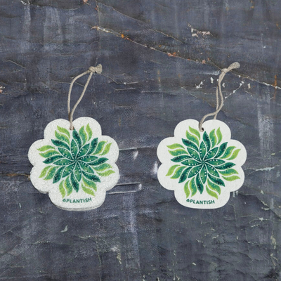 This top-view comparison showcases the Leaf pop-up sponge in both dry and wet states. The right image displays the sponge in its dry form - flat and compact, while the left demonstrates its expanded, thicker cleaning pad state after hydration. Both versions clearly feature the charming Leaf design and come with an attached hanging string. Photographed against a dark grey textured background, this eco-friendly kitchen cleaner exhibits remarkable size expansion when water is absorbed
