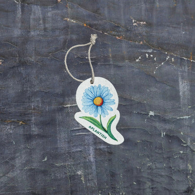 Top view of an eco-friendly cellulose pop-up kitchen sponge featuring a delightful blue daisy pattern, complete with hanging cord. This innovative cleaning tool lies completely flat when dry (just 0.3cm thin) for space-saving storage, then expands to a full 1.5cm thickness when wet for superior absorbency. Made from 100% biodegradable plant-based cellulose, the sponge combines sustainable functionality with charming floral aesthetics - the vibrant blue daisy design adding a cheerful touch to kitchen chores 