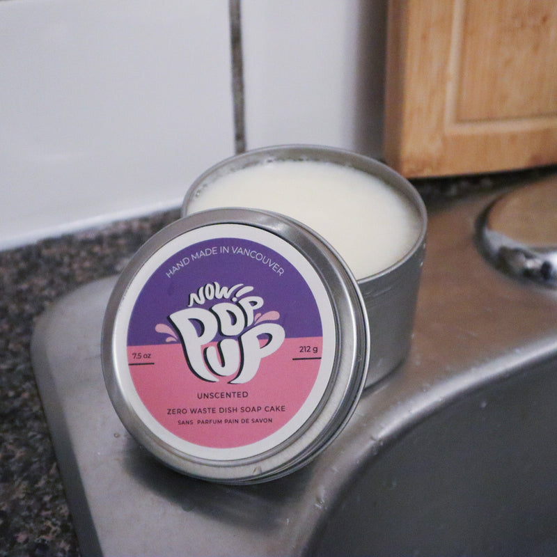 The dish soap cake on a kitchen counter with a sink in the background