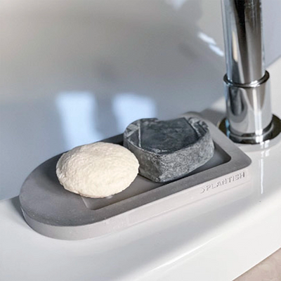 Side view of the Plantish Future Home & Kitchen Self-Drying Soap Dish. Biodegradable dish soap tray designed to dry soap and promote sustainability in the home. Compatible with dry soap bars for an eco-friendly cleaning solution.