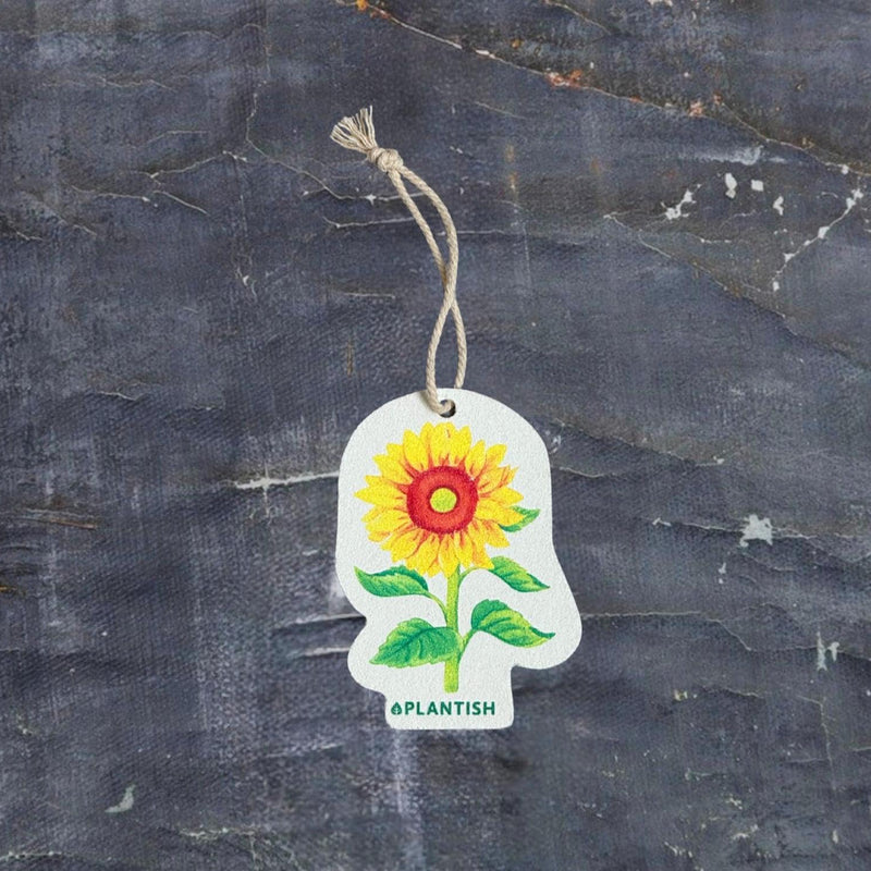 A white pop-up sponge featuring a cheerful sunflower design, with bright yellow petals and vibrant green leaves—adding a touch of nature to your kitchen routine.