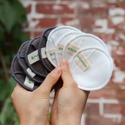 Hands holding make up pads for eco friendly skincare routine.