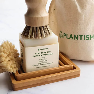 Sisal and palm pot scrubber on top of solid dishwashing bar soap.