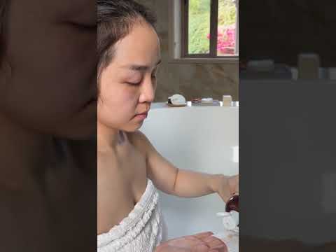 Video of woman using cotton face rounds to remove makeup and cleanse skin.