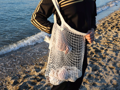 Person carrying Net Tote bag on beach