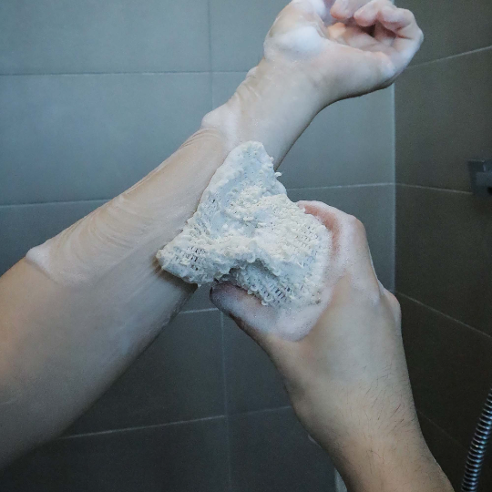 Plantish Future Beauty and Bathroom Soap Bag with soap scrubbing an arm in shower